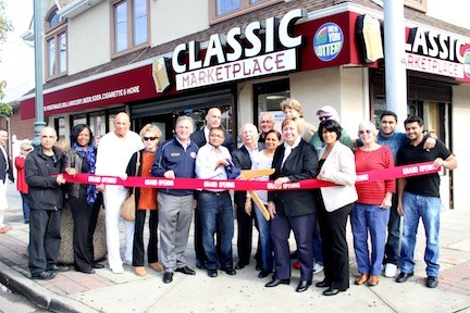 Mayur Shah, his wife Kalpana and sons Sahaj and Kru with VIPs and Island Park Chamber of Commerce members at the grand opening of the Classic Marketplace on Nov. 2. Five stores and restaurants reopened their doors that day, more than a year after Sandy.
