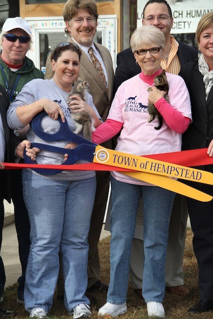 Nadine Cohen, VP and Carol Meyer, President, holding kittens Darlene and Tabitha, get ready to cut the ribbon on the new Kitty Cove.