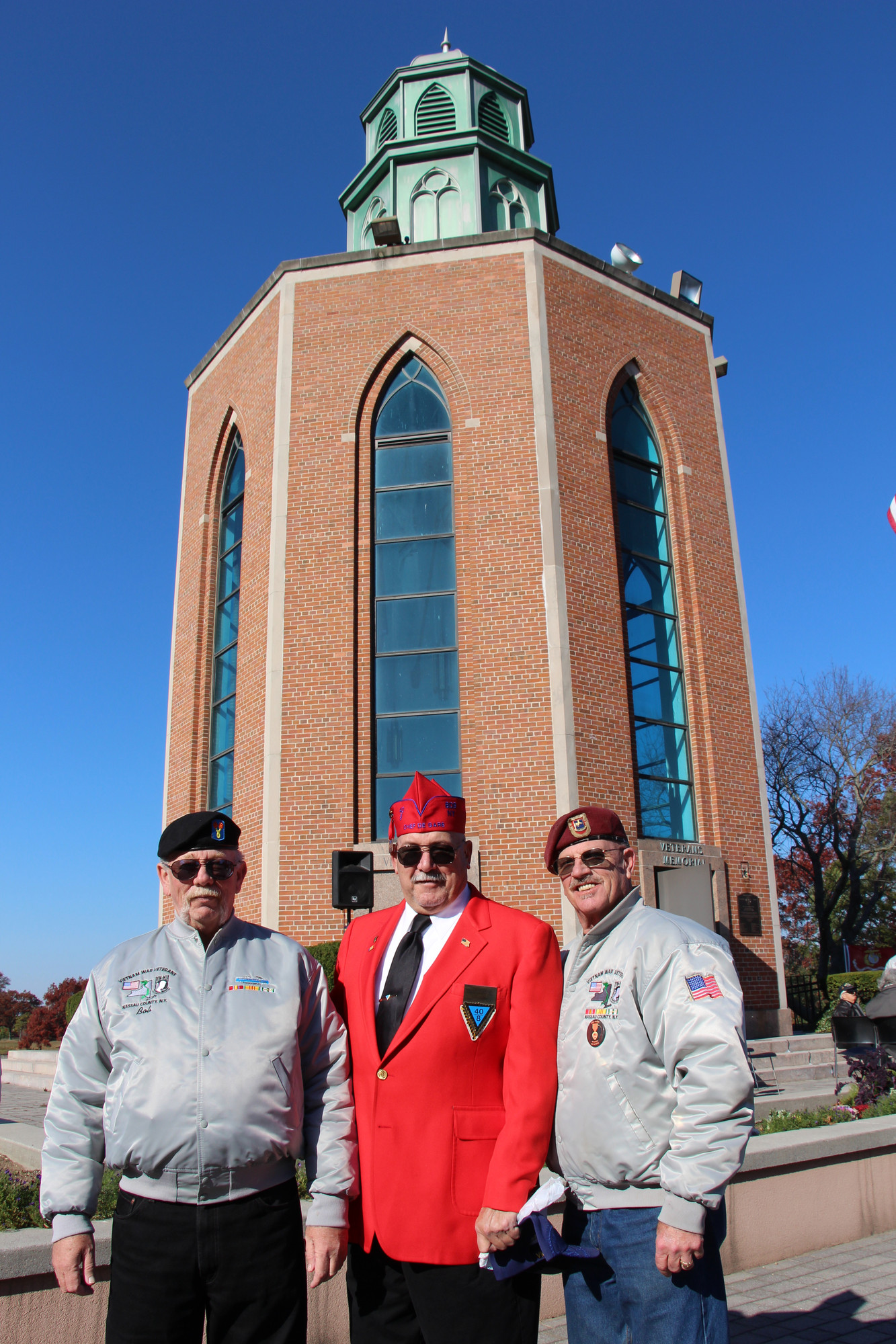 Pat Yngstrom, of Merrick, Kevin Lawlor, of East Rockaway, and Bob Reichel, also of Merrick, joined together in Veterans Memorial Plaza in Eisenhower Park on Sunday.