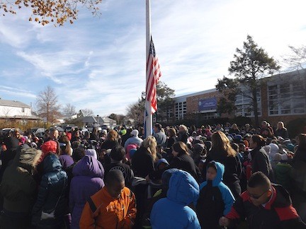 Students and staff watch as the Blue Ribbon flag is raised during a morning ceremony on Nov. 20.