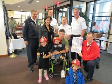 Pictured from from last year’s trip is Marine Marcus Dandrea and his family with members of the LFD.
