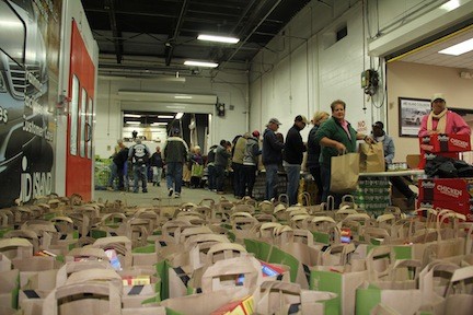 Thousands of dollars worth of food was purchased by Robert Jesberger, owner of Mid-Island Collision in Rockville Centre, and is being donated to families in need across the area. Volunteers from all over the Long Island gave their time on Tuesday to help pack up bags of food for distribution.