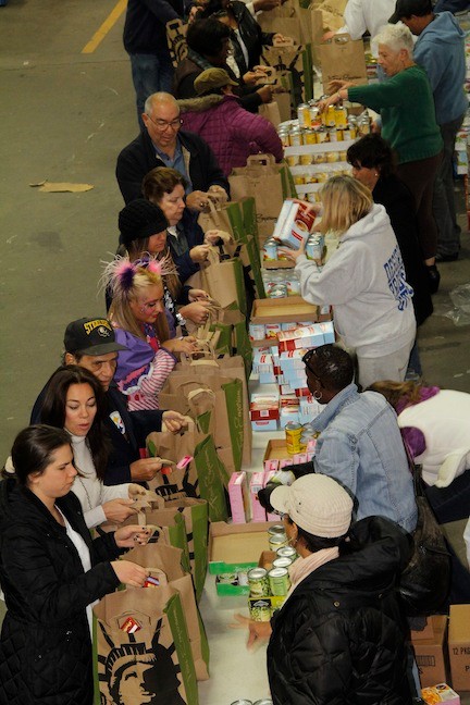 Many a volunteer came to pack up bags of food.