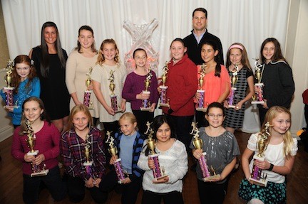 The Art Flowers team posed with their trophies in front of the Little League ice sculpture.