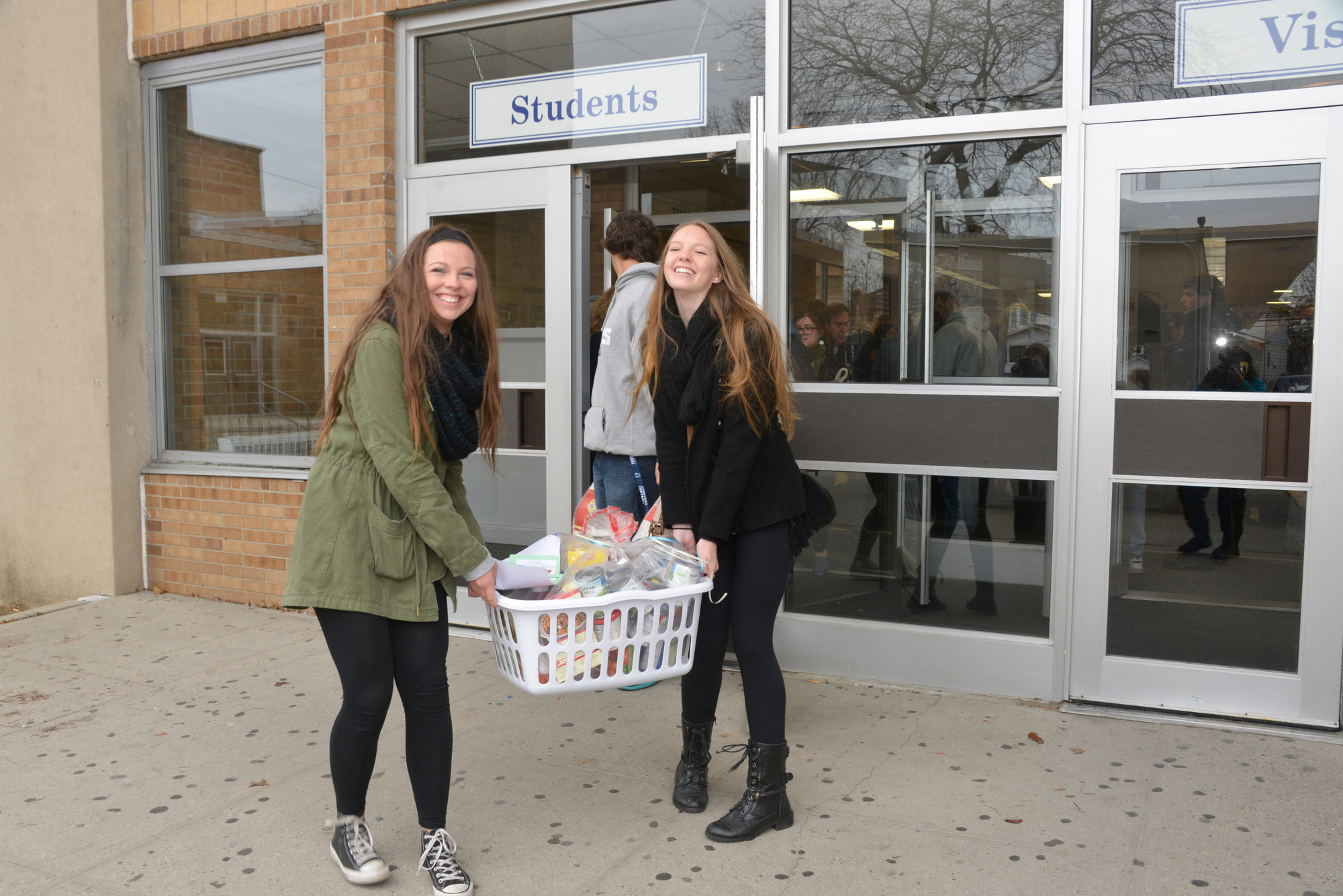 Jillian Pointek and Veronica Miller at the OHS turkey Shoot carry baskets of  food to deliver  neighbors