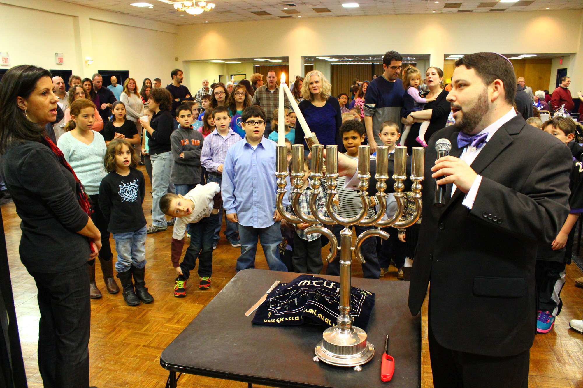 Rabbi Daniel Bar-Nahum of Temple Emanu-El, and congregant Lisa Shubin, lit the menorah in front of a large crowd of young spectators.