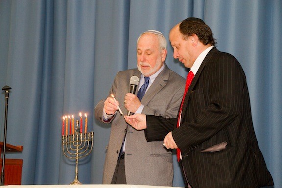 Rabbis Elliot Skiddell and Howard Diamond lit the menorah.