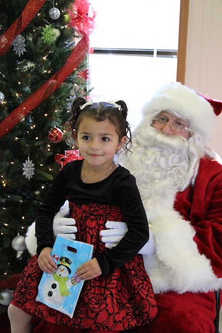 Gabriella Battaglia, 4, sat on Santa’s lap, as she told him what she wanted for Christmas.