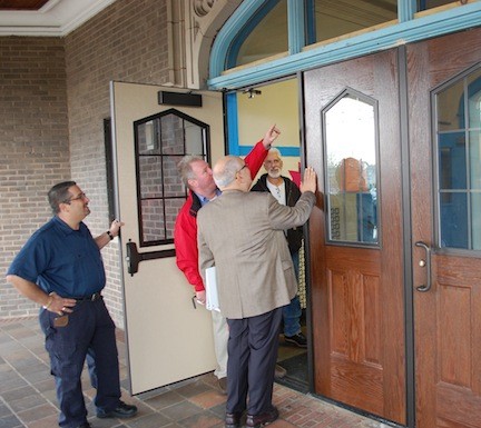 District 13 facilities director James Daly shows Board of Education Trustee Frank Chiachiere the new doors that were installed at Wheeler Avenue School’s main entrance.