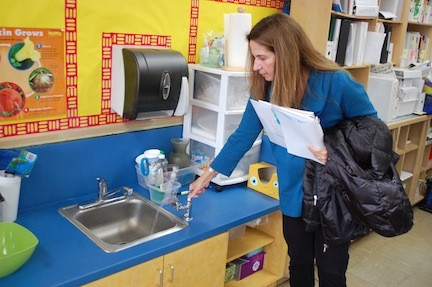 Board member Toni Pomerantz looks at one of the new sinks in a classroom at the James A. Dever School.