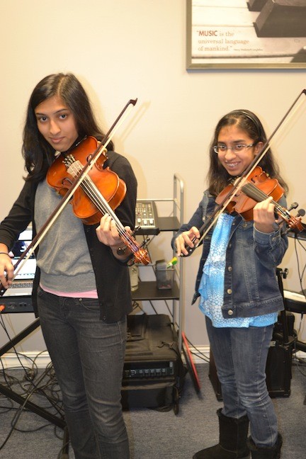 Binita Shah, 16, of W.T. Clarke High School, left, with sister Aashini Shah, 13, of Clarke Middle School, during a recent rehearsal.