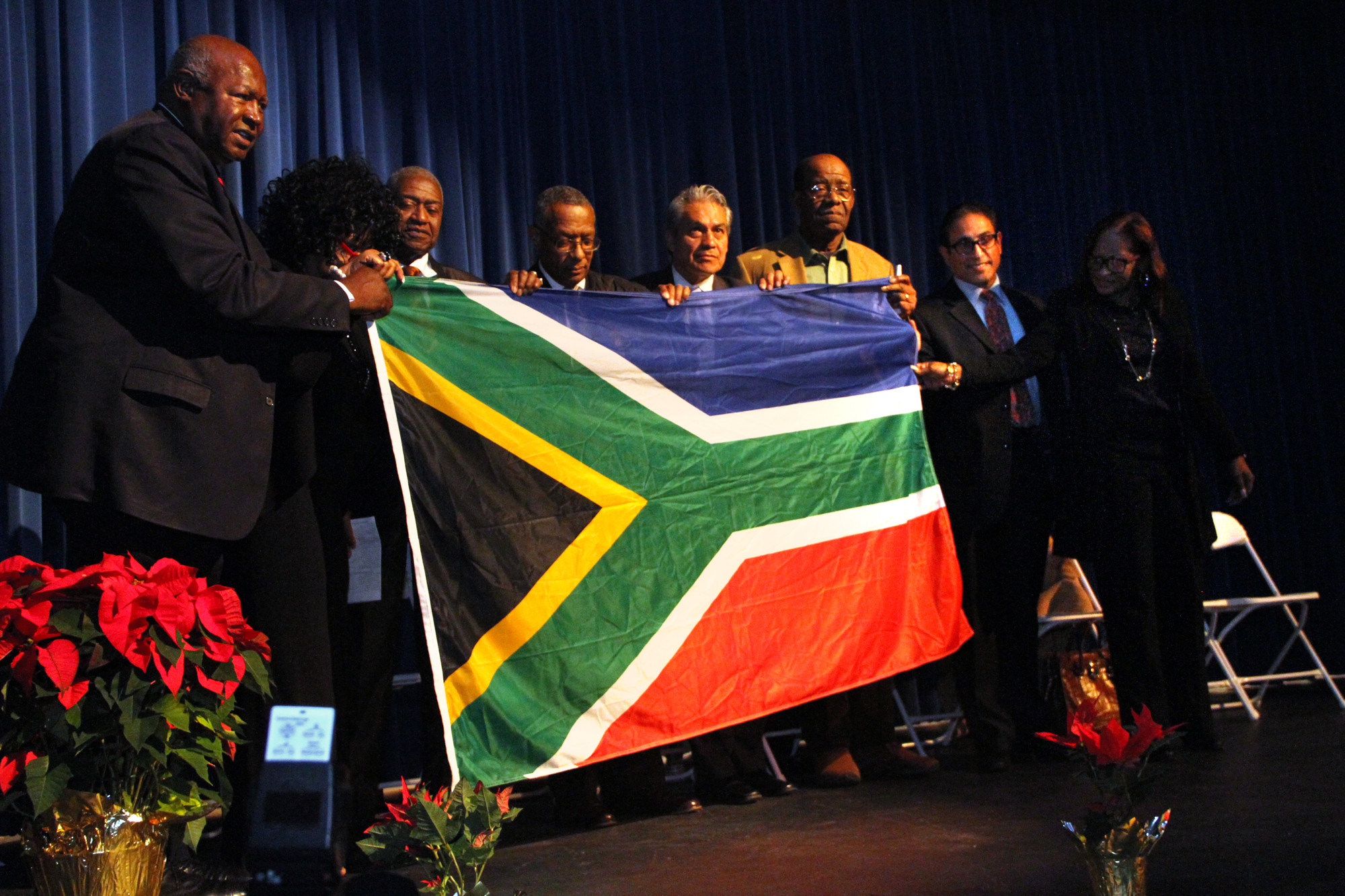 Former Hempstead Mayor James Garner, left, displayed a South African flag he said Mandela gave him. Garner was a delegate to the United Nation’s 2002 World Summit on Sustainable Development in Johannesburg.