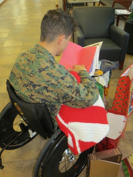U.S. Marine Cpl. Marcus Dandrea read one of the cards written to him by a Lynbrook resident.