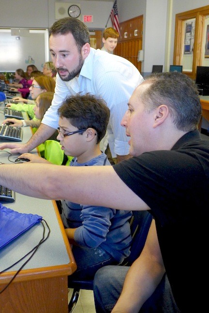 Adam Chernoff and his dad, Barry, get some help in the Graphic Design workshop from OHS technology teacher Michael Lawton.