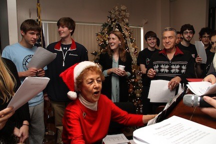 Betty Bergbuchler led a group of Sandel Senior Center members and South Side High School students in song at the Intergenerational Holiday Party on Monday.