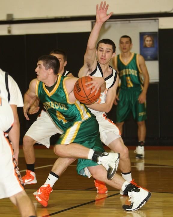 Lynbrook’s Mike McVeigh looked to get free as East Rockaway’s Danny Fusco defended during the Owls’ dramatic 60-57 win over the Rocks last Saturday in their 77th annual Friendship Games.