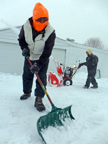 Jermaine Ewell shoveled as snow kept falling on Friday morning.