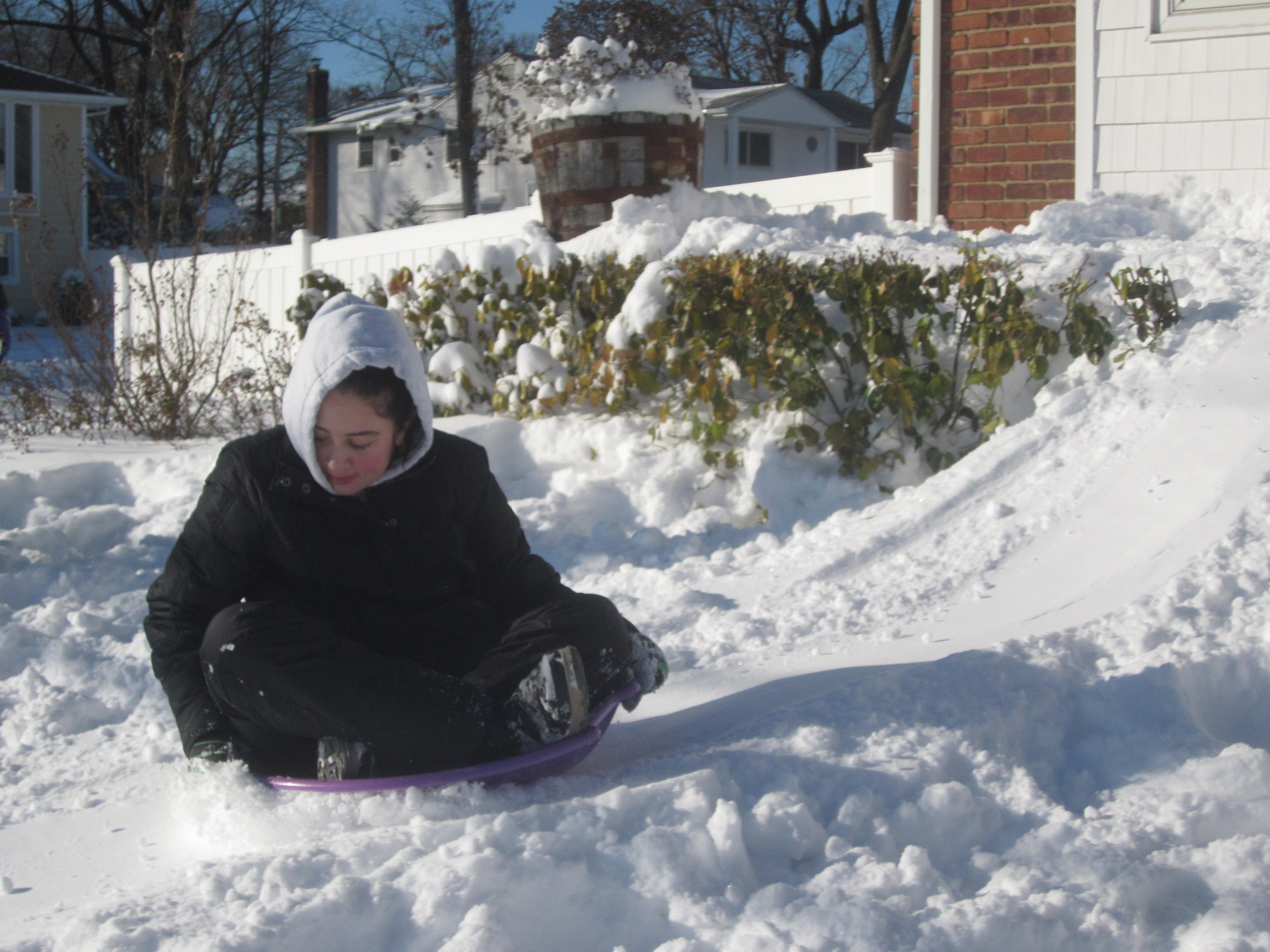 Sara Polansky, 13, made a makeshift sledding course in front of her Luddington Avenue home.