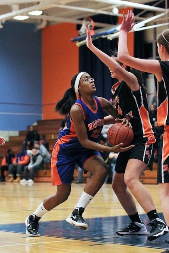 Malverne's Kym Danns, left, drives the lane during the Lady Mules' hard-fought defeat against visiting East Rockaway on Jan. 7.