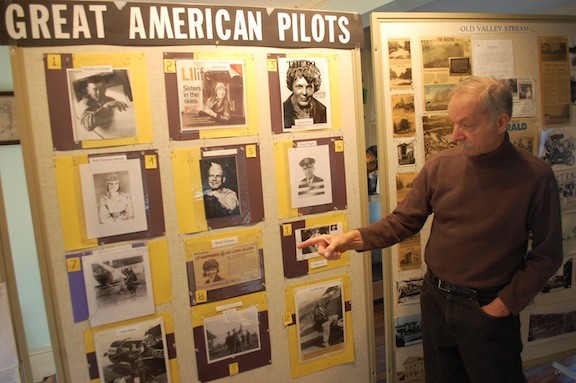 Historical Society President Guy Ferrara shows his new display on famous pilots at the Pagan-Fletcher Restoration, Valley Stream’s local history museum.