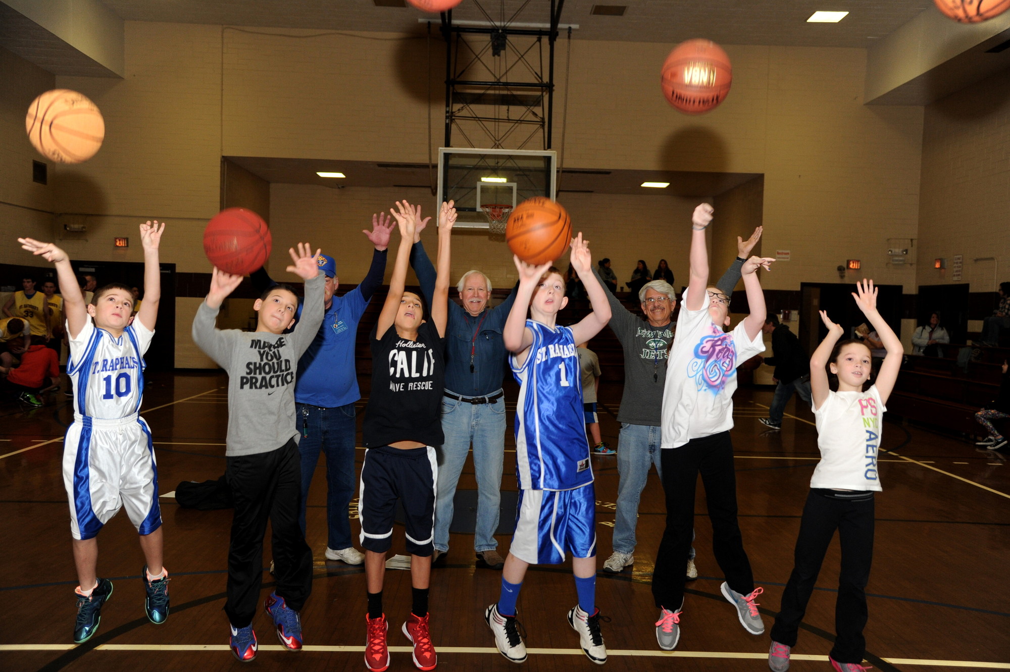 Nicholas Giardino, 9, far left, Jordan Chalmers, 10, Tyler Luciano, 12, Brendan Wilkowski, 11, Kerry Clark, 11, and Lindsay Solenski, 9, were among the winners of the Pope Pius XII Knights of Columbus annual free throw contest last Saturday at St. Raphael’s Parish. Behind them, event organizers John Devany, partially obscured at left, Paul Wissert and Alan Bacci cheered them on.