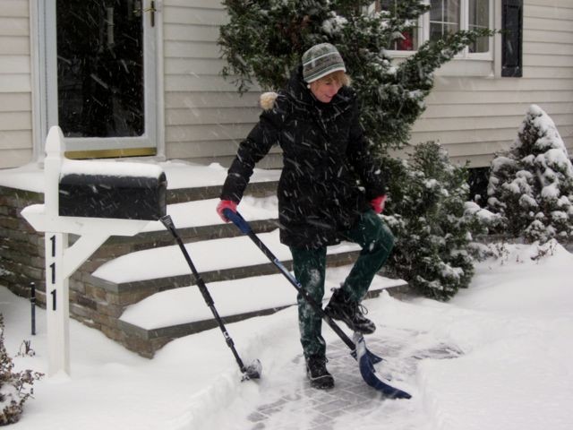 Jennifer McTague finished cleaning up the walk of her Burtis Avenue home, for what will likely be the first time of many over the next two days.