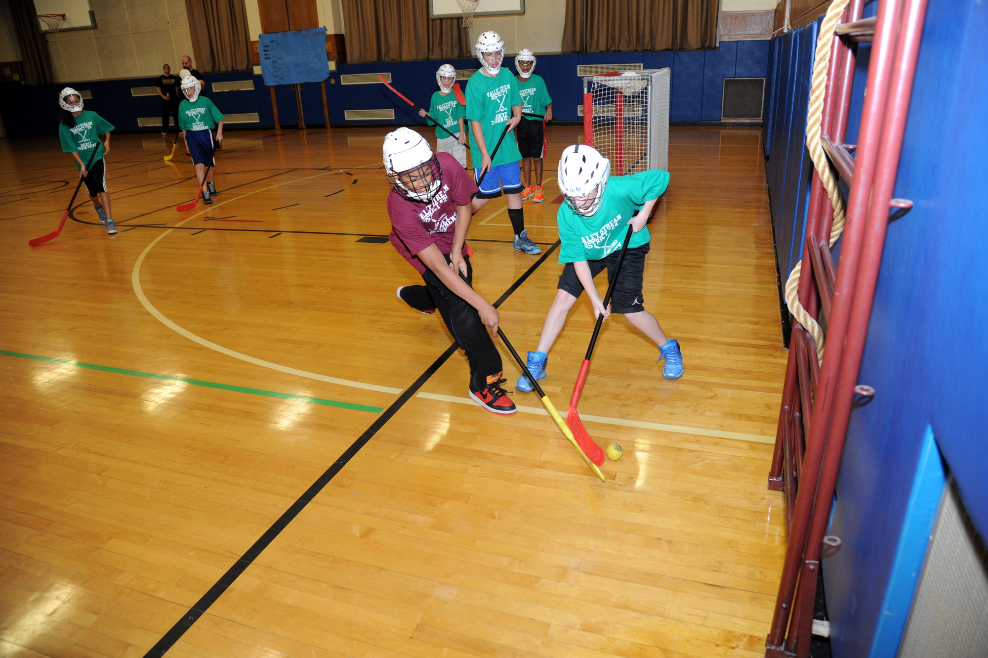 Players battled for the puck in the William L. Buck School gymnasium.