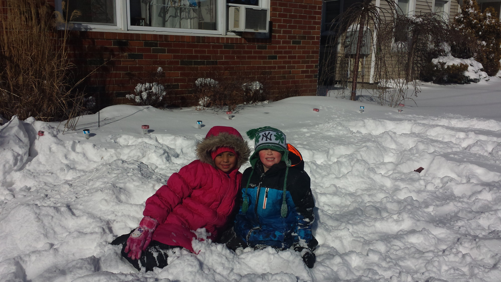 Bella Rush and Danny Casey enjoyed the snow outside of a Fifth Street home in Valley Stream on Wednesday.