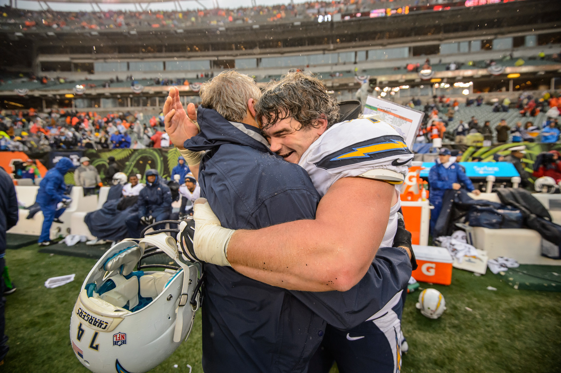 Rich Ohrnberger, a 2004 East Meadow High School graduate, in an emotional embrace with a San Diego Chargers coach following the team’s playoff victory over the Cincinnati Bengals on Jan. 5.       Photo courtesy of Mike Nowak/San Diego Chargers
