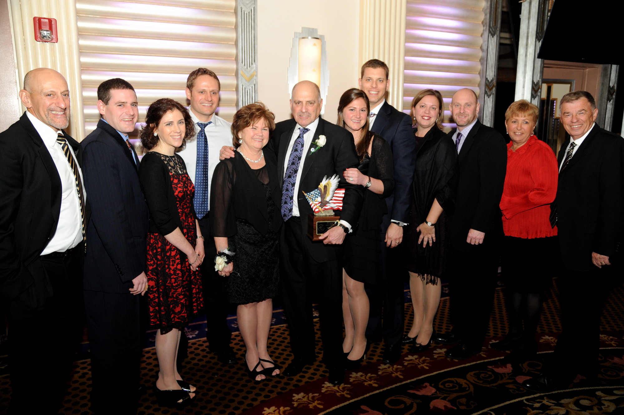 Alan Hodish, sixth from left, was honored as Man of the Year. He was joined to his right by his wife, Denise, and the rest of his family and friends.