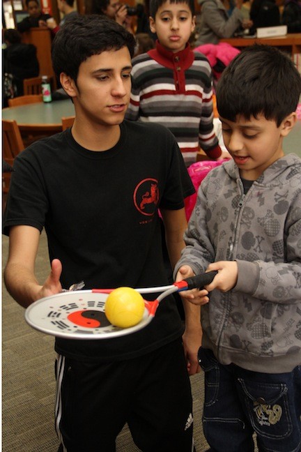 Cultural Society member Marcello Rivera worked with children to teach them traditional Chinese activities.