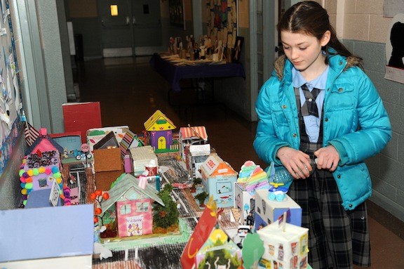 Rebecca Carey, 11, looked over projects in the social studies fair.