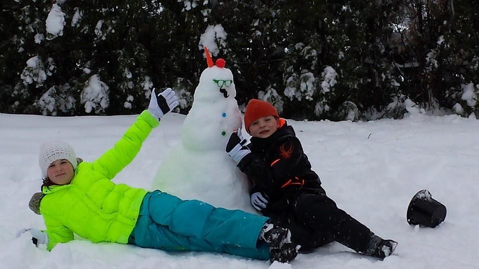 Megan and Owen Ward, 10-year-old twins from Valley Stream, pose in front of their snowman during their snow day.