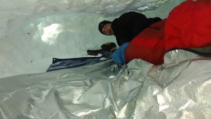 Alex Maher settled down for the night in his quinzhee, a shelter made by hollowing out a pile of settled snow.