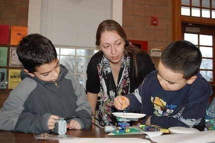 Kathleen Scatigno helped Drew Levitan and Leon Alert with their spin art project at the Firemen’s Field Clubhouse on Feb. 12. The boys built a Lego motorized machine, then applied paint to a spinning canvas.