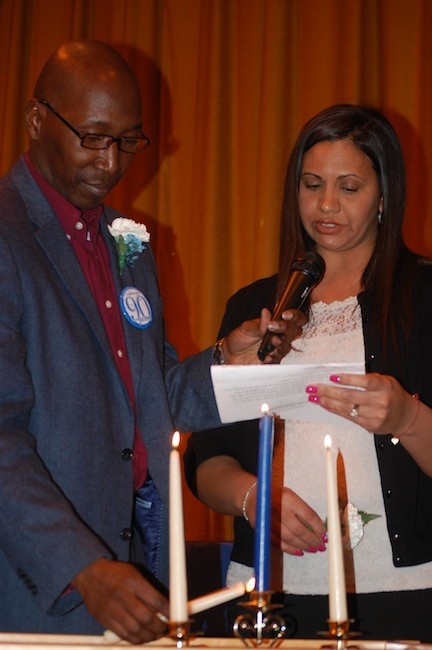 Forest Road PTA leaders Kenroy Woodley and Natalie Cange lit candles in the Founder's Day ceremony.