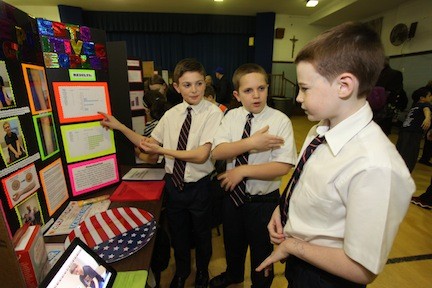 Theo Franks and Vincent O’Connell demonstrate to their good friend Patrick Burke their project on skin prick tests and their false/positive results on food allergies.
