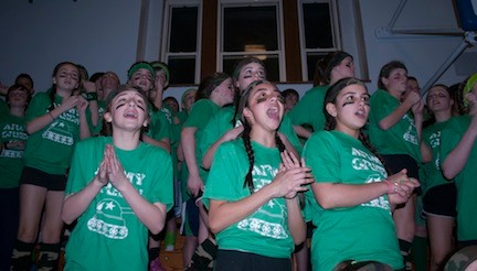 The 7th Grade girls cheered for the boys on their team during the Tom and Jerry event at St. Agnes Cathedral School for Green and Gold night last Friday night.