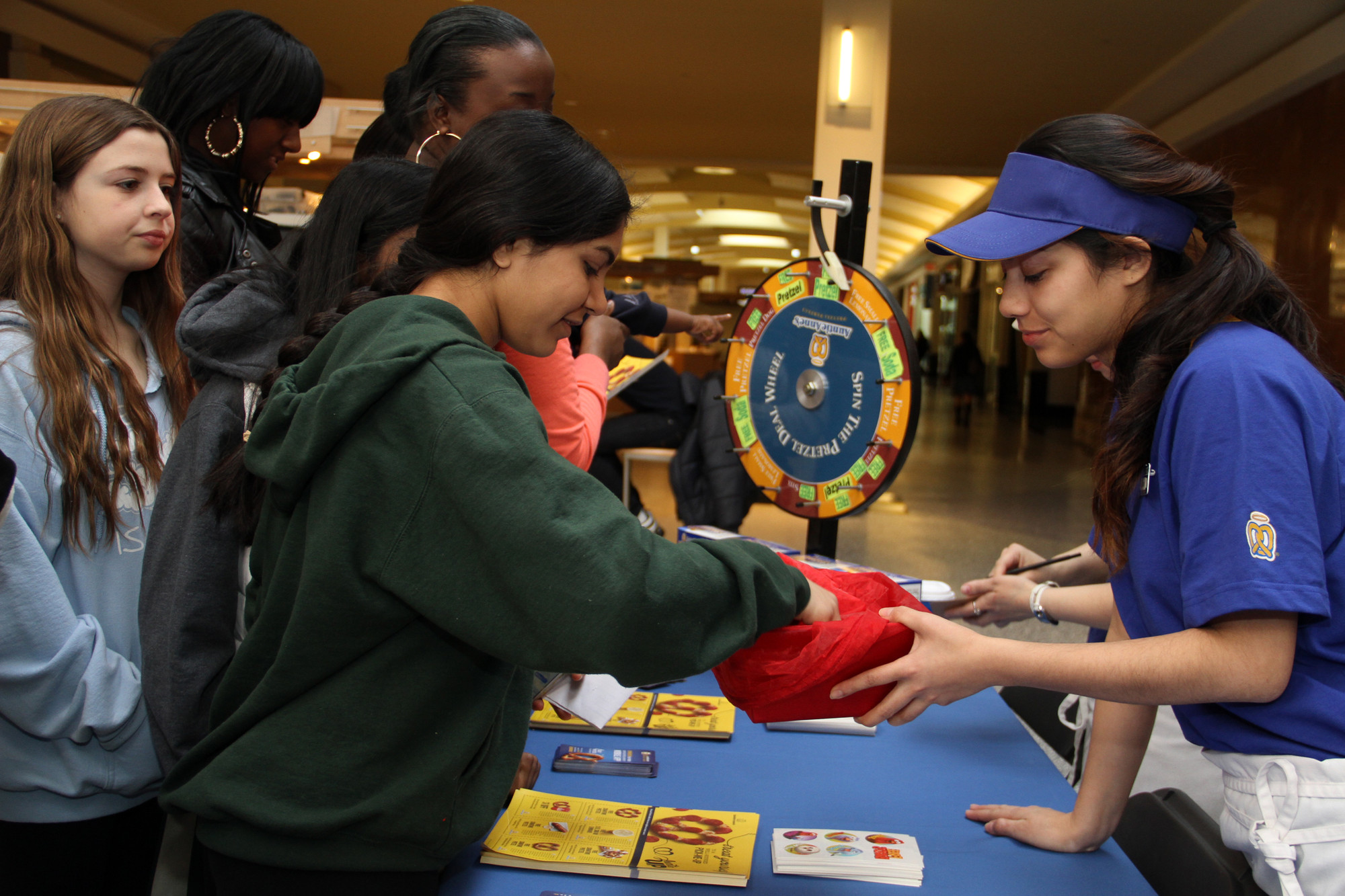 Student Arham Ansari draws for a spin on the “Auntie Anne’s” prize wheel.