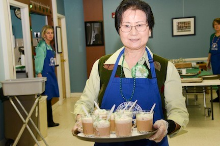 Jan Cho served Irish coffee at The St. Patrick’s Day celebration.