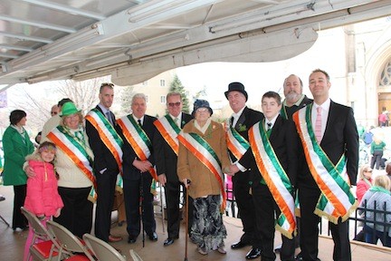 Grand Marshal Sean O’Rourke, fourth from right, had friends and family members on the stage, including, from left, Nevaeh O’Rourke, Parade Committee President Kathy Schwarting, Thomas Emmet O’Rourke, Thomas Henry O’Rourke, Patrick O’Rourke, his mother, Bridget O’Rourke, Thomas Declan O’Rourke, Mayor Francis X. Murray and Nick Zottoli.Nevaeh O'Rourke,  Kathy Schwarting,  Thomas emmet O'Rourke, Thomas Henry O'Rourke, Patrick O'Rourke, Mrs. Bridget O'Rourke (mom, from County Galway, Ireland), Grand Marshall Sean O'Rourke,  Thomas declan O'Rourke, Mayor Francis X. Murray, Nick Zottoli.