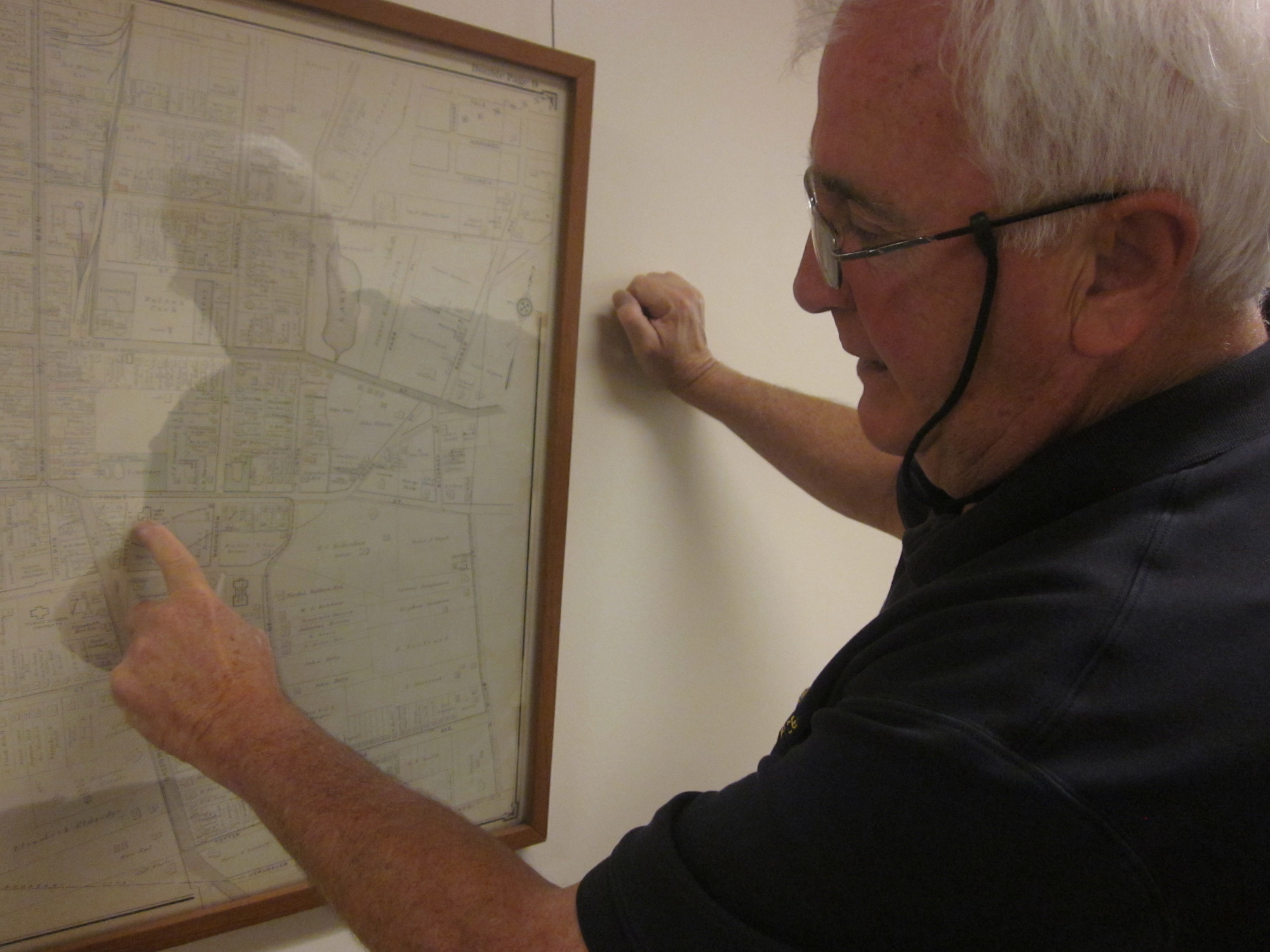 Thomas Saltzman explained the history of the Town of Hempstead’s many villages while pointing at the page of an E. Belcher Hyde atlas.