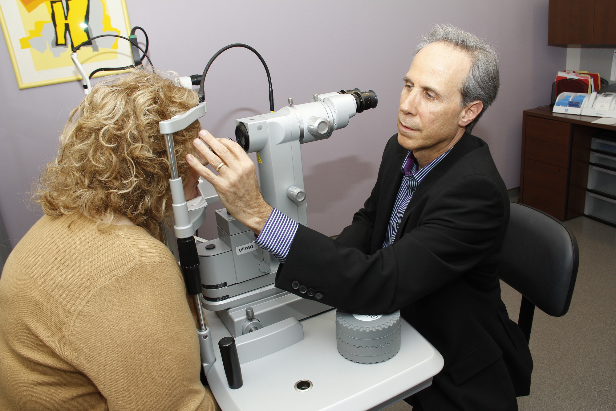 Dr. Stanley berke examines a patient in his state-of-the-art Westbury office.