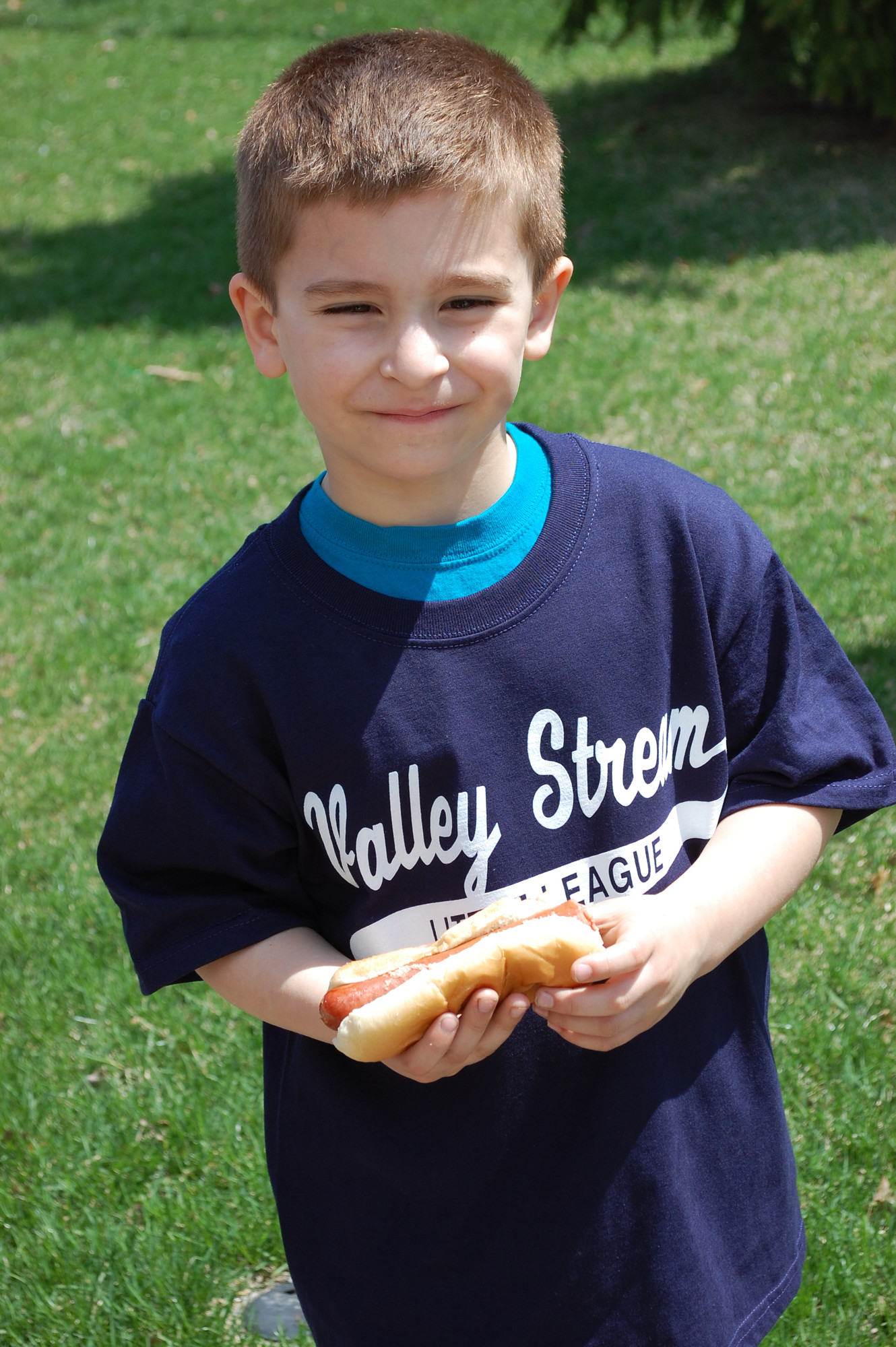 Nicholas Galanis, 5, playing in the league for first time, enjoyed a hot dog after the ceremony.