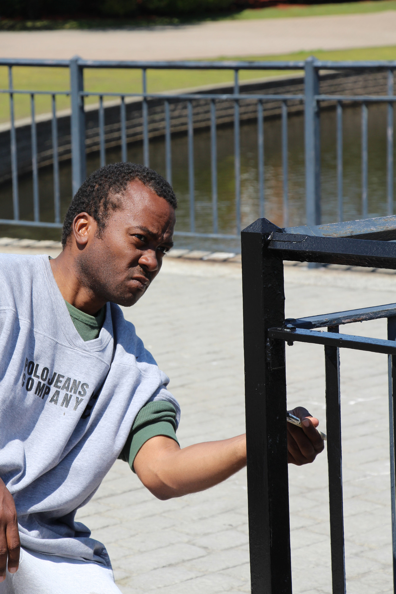 Richard Moore helped out at Milburn Pond Park. He painted the railing along the pond, giving it a needed face lift.