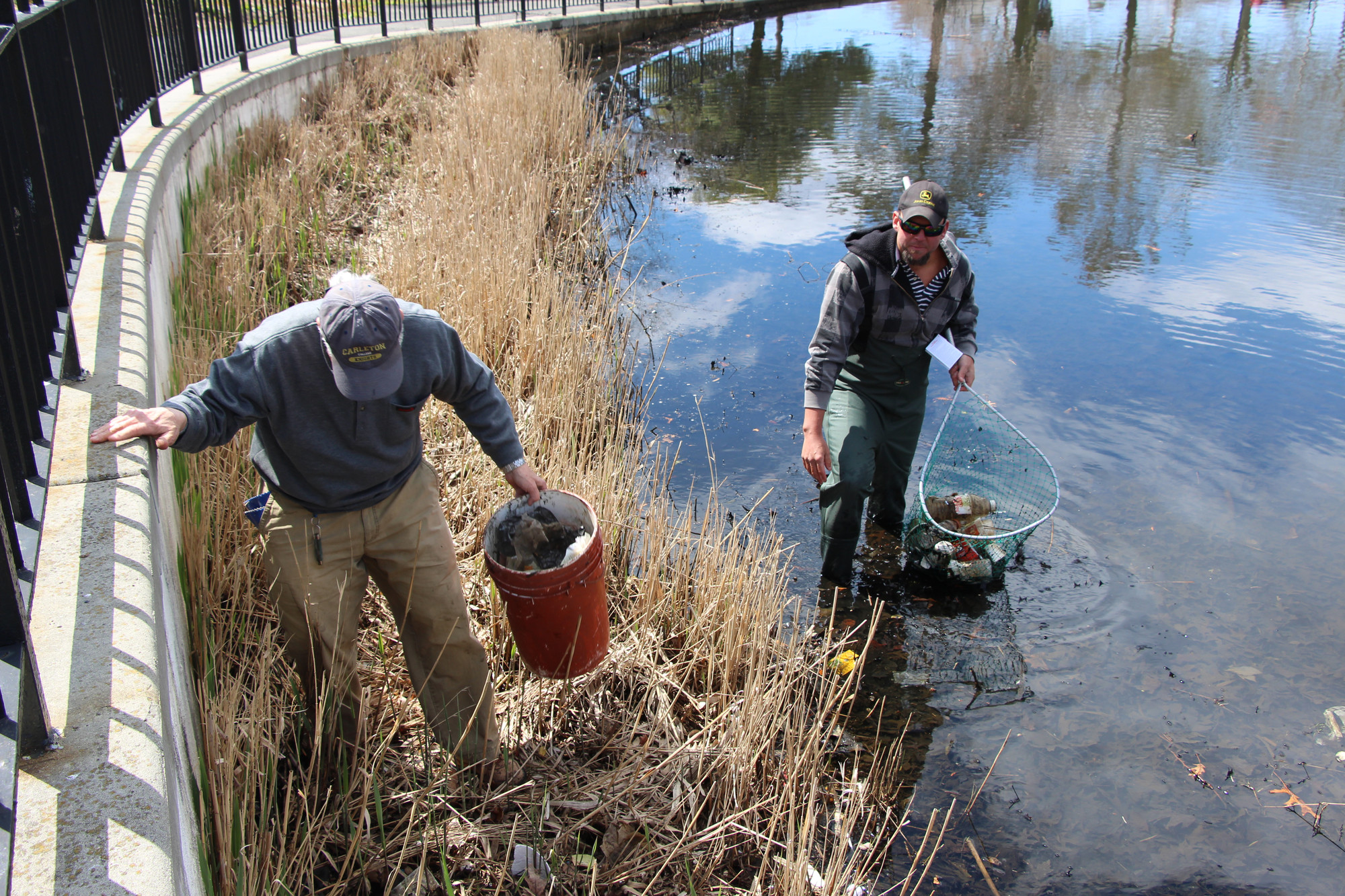 Erik Mahler, right, and Tom Bertock got into Silver Lake to pull out debris, plastic bottles, papers and other litter as part of Baldwin’s Earth Day Cleanup on April 26 at Sliver Lake and Milburn Pond parks.