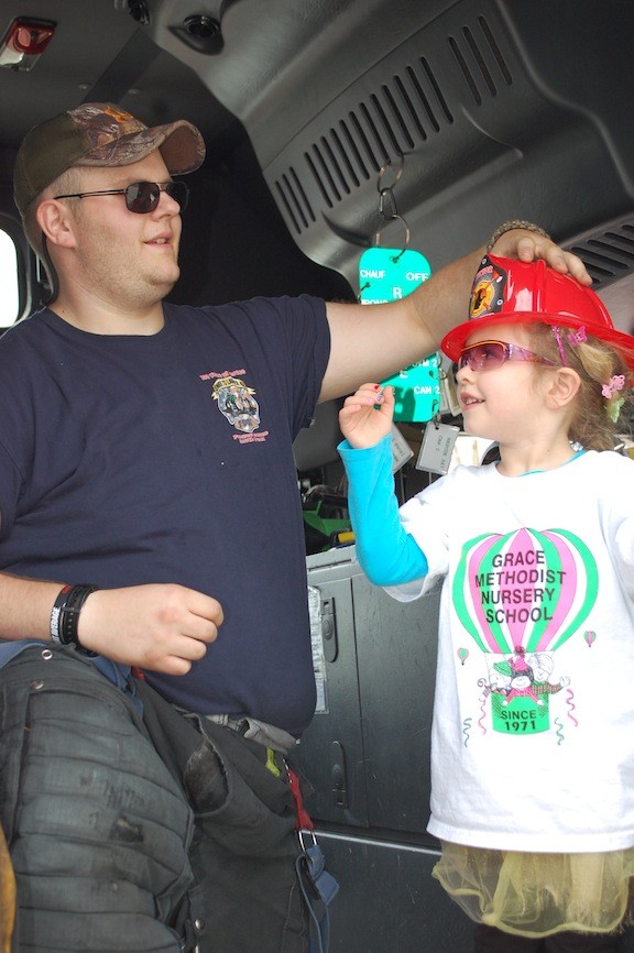 Steve Lauria, member of Rescue Company No. 1, gave 3-year-old Kayla DiMaio a free fire helmet.