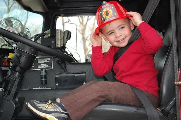 Sean Hawkins, 2, got to check out a Valley Stream fire engine, and got some souvenir headgear, at the village’s annual Truck Day program for nursery school students last Friday afternoon at Hendrickson Park.