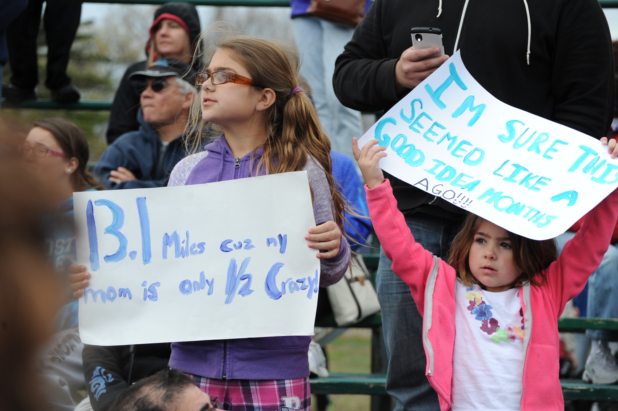 Julia Monte, 9, and sister Carly, 5, held signs of encouragement ... sort of.
