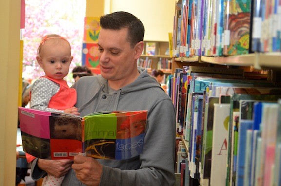 Vincent Matthews read a book to his 14-month-old daughter Emily.